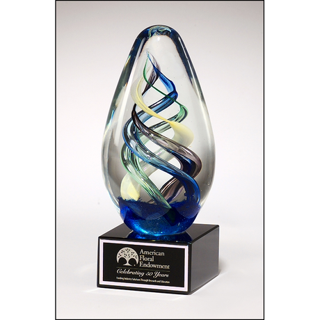 Egg-shaped art glass award on black glass base.