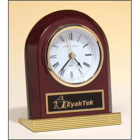 Rosewood piano-finish clock with gold metal base.