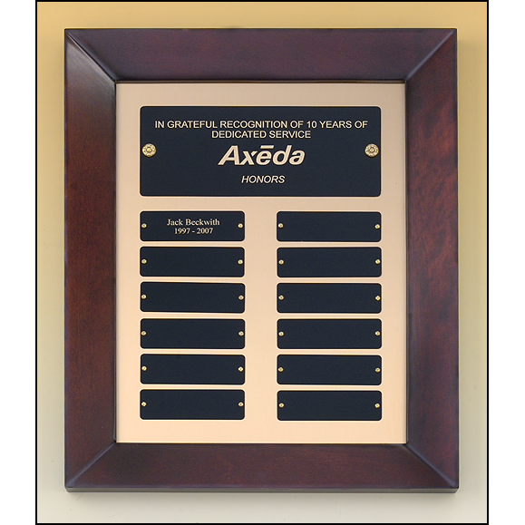 Cherry finish frame perpetual plaque with 12 black brass plates on brush metal gold background.